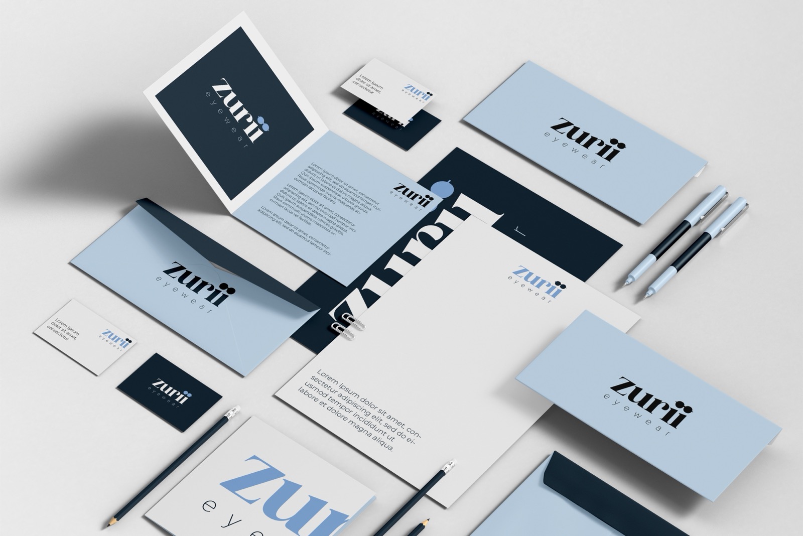 Zurii Eyewear stationery set in navy and powder blue: business cards, letterhead, folders and pens